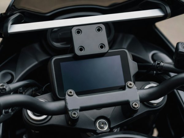 Motorcycle cockpit showing 12mm upper navigation bar with AMPS 4-hole mounting plate above TFT instrument cluster